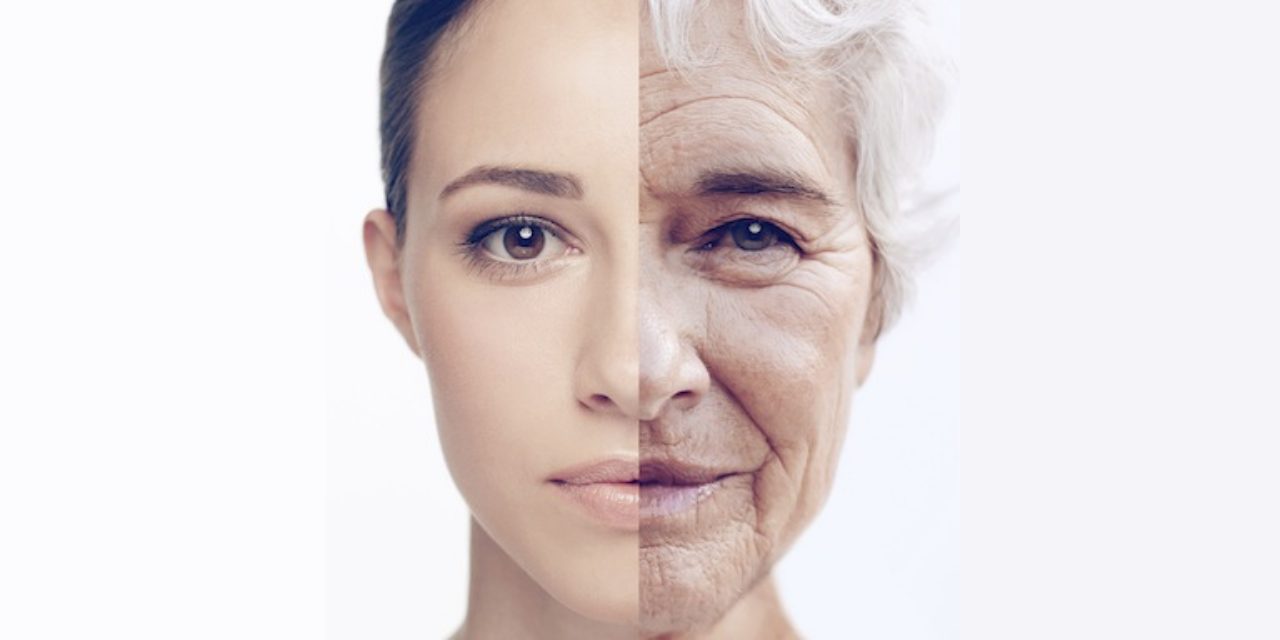 A face split down the middle, young on one side and old on the other